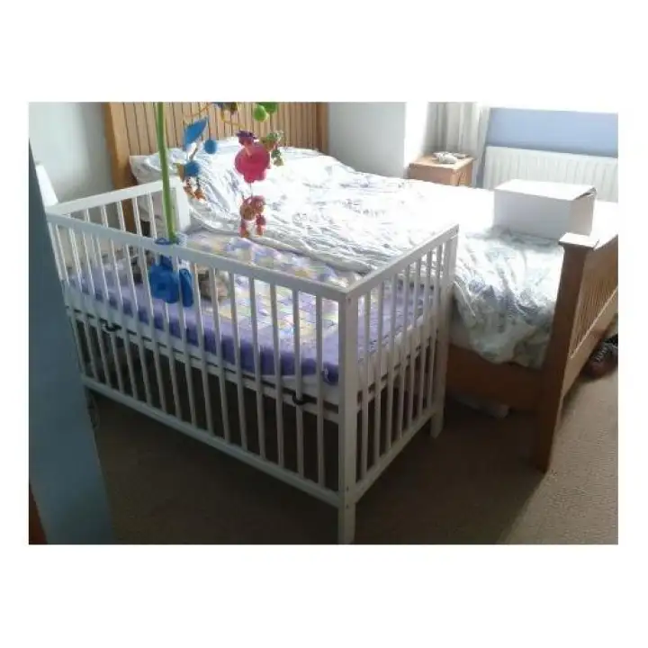 crib beside bed