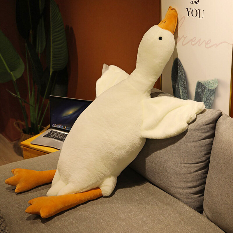 Children's plush toy big white goose lying on the pillow doll doll