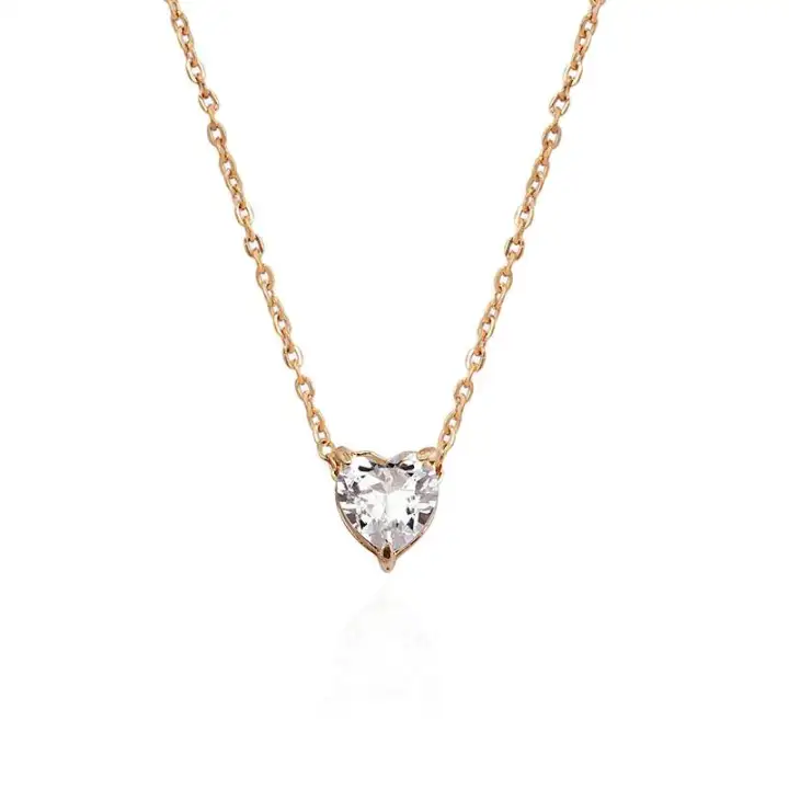 short gold necklace with charm